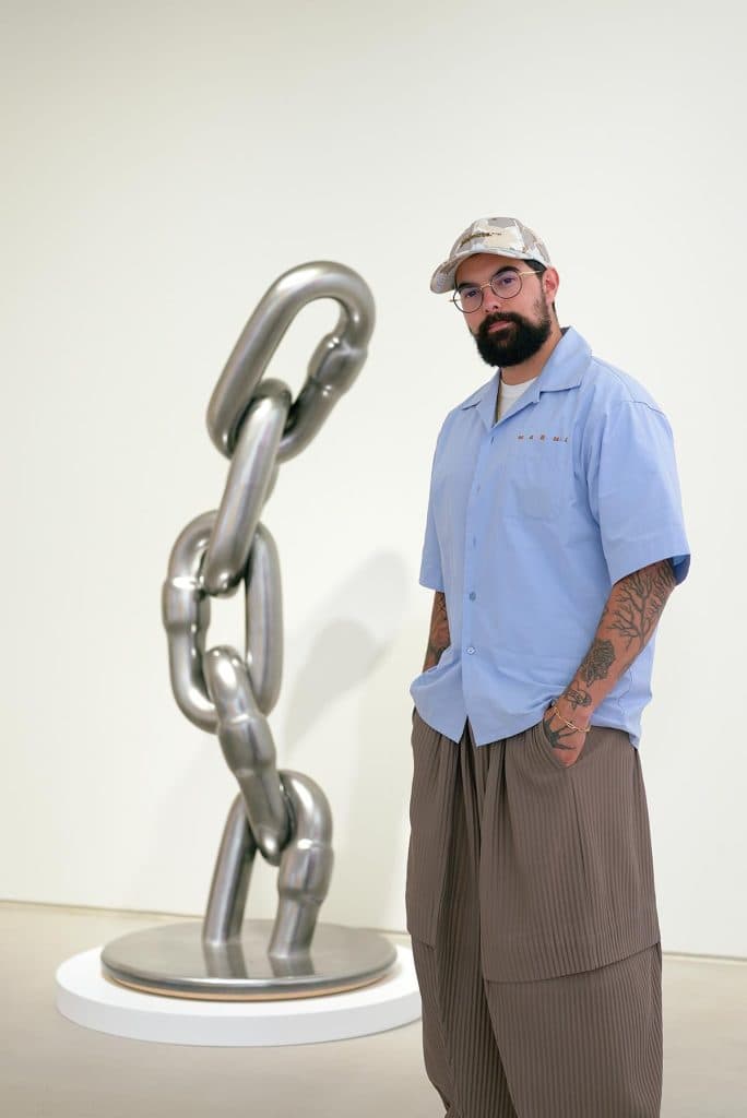 Frédéric Duquette, known as Fvckrender, beside a chain sculpture