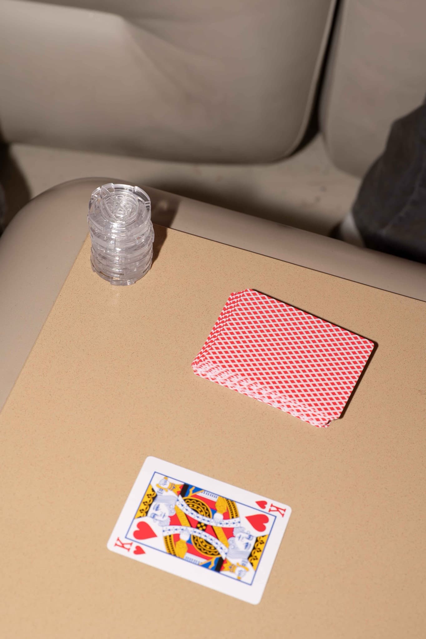 Finite chips and playing cards on a table at Artifact