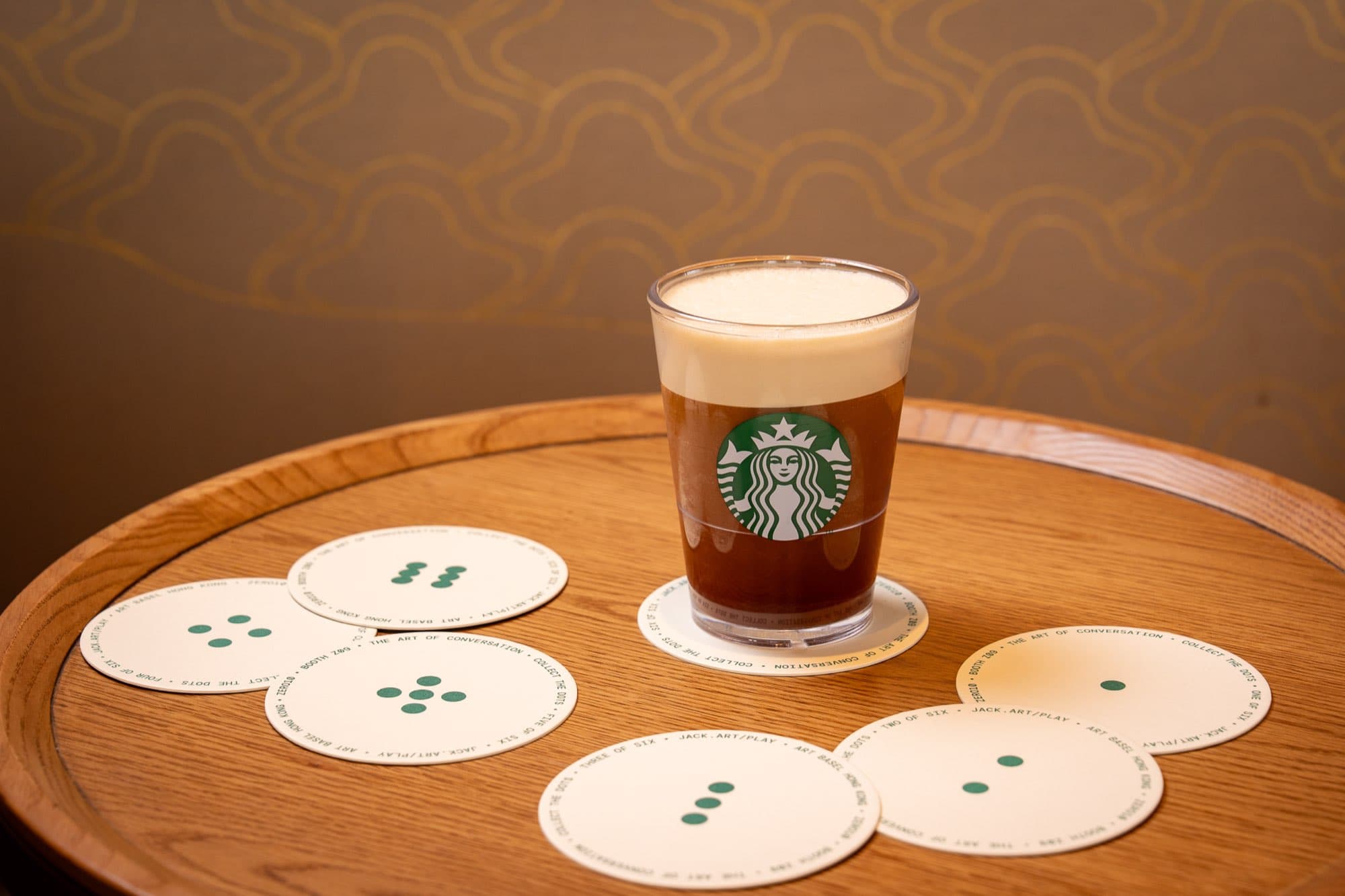 Starbucks x Jack Butcher coasters around a Starbucks cup