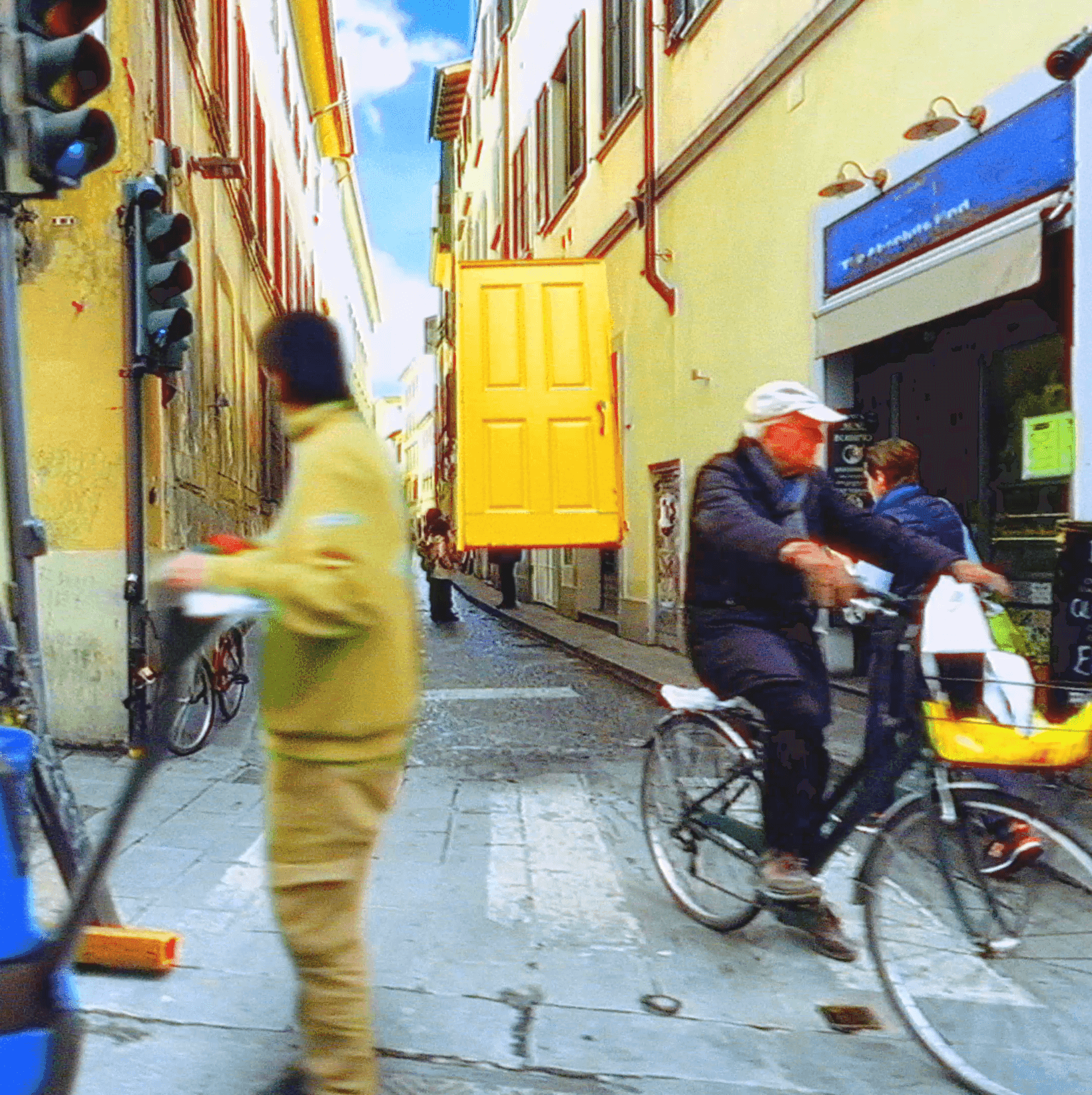 Man with flowers by yellow door